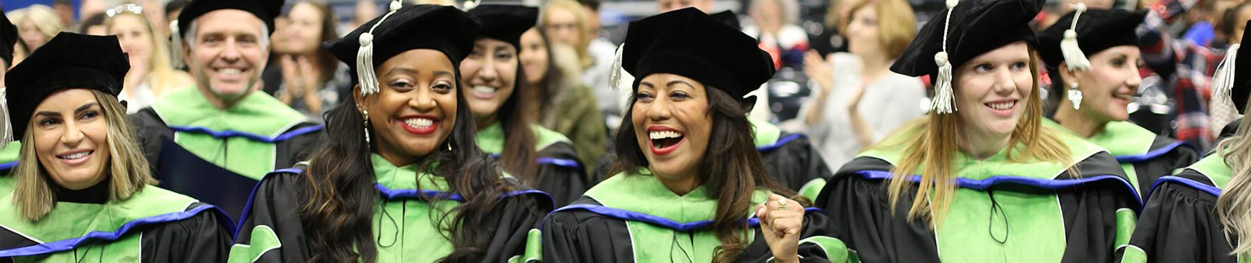 students smiling at graduation